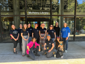 Members of UC-AFT in blue shirts standing outside McHenry library.