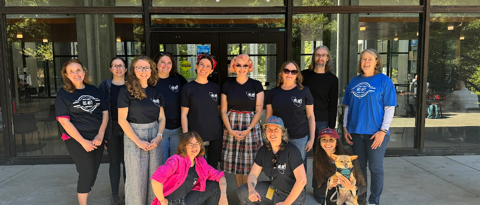 Members of UC-AFT in blue shirts standing outside McHenry library.