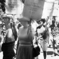 Black and white image shows a march of faculty, staff, and students at UC Davis during UC-AFT's strike in 2003. The woman featured in this image are carrying pickets that read "On Strike - UC Davis Lecturers - Local 2023 UC-AFT"