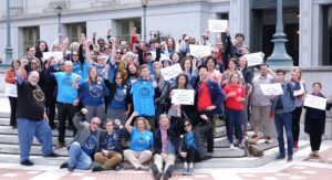 A group of lecturers, librarians, and students gather outside a bargaining session at UC Berkeley in 2018. Some hold signs reading "Support World Class Librarians".