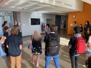 Lecturers and their students stand in a lobby listening to an administrator speak during an action at UC Merced in 2022.