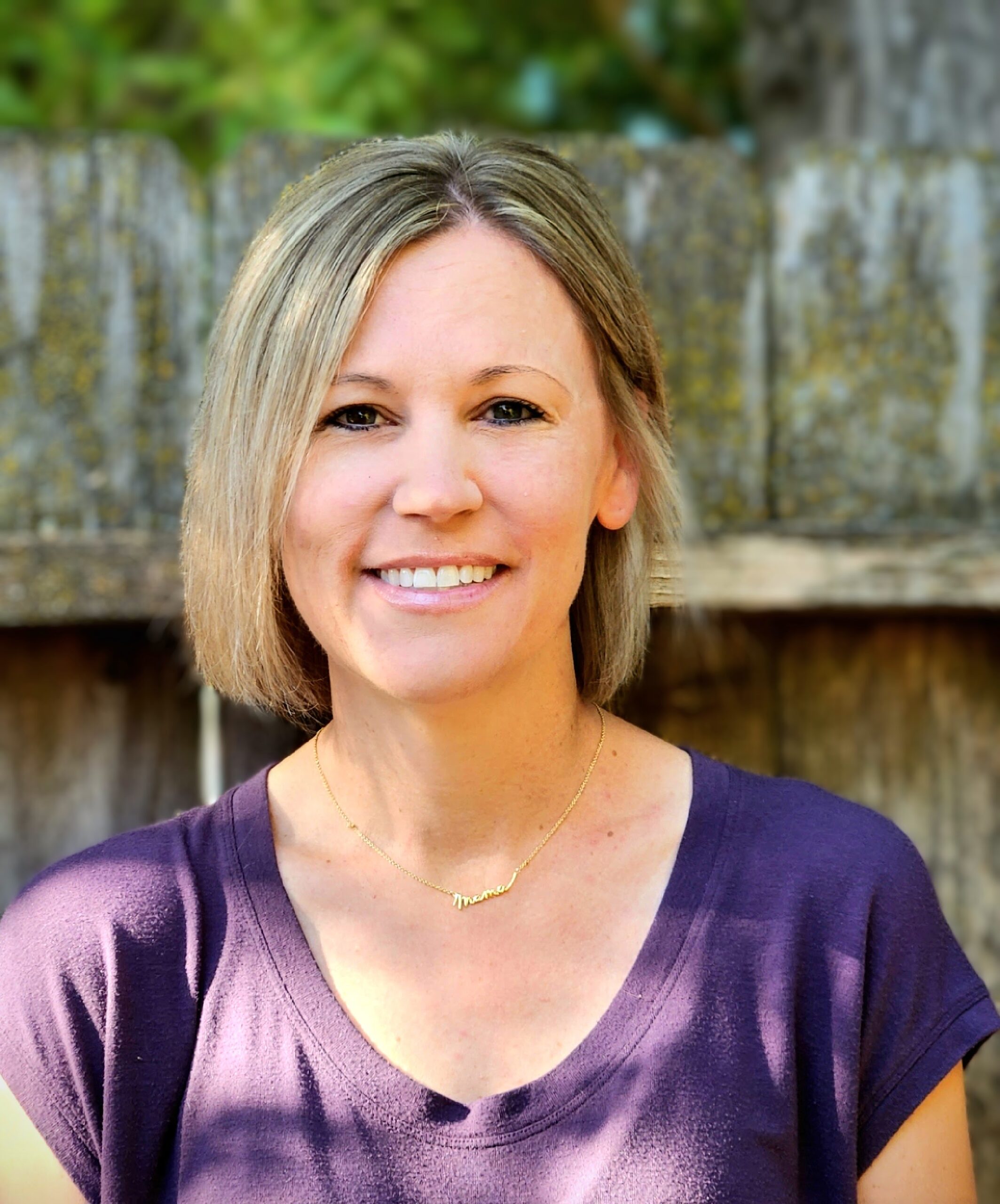 Blonde-haired woman in a purple top