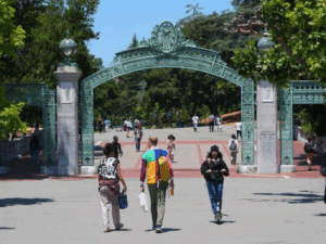 students strolling through the iconic gate to UC Berkeley campus